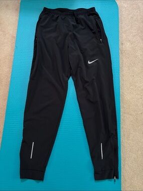 Nike Black Track Pants with White Swoosh and Reflective Accents